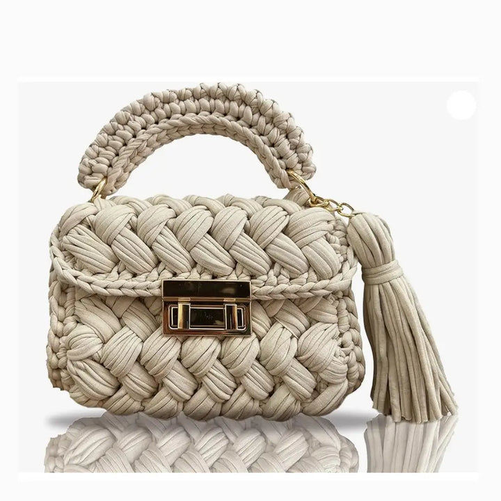 FASON DE VIV beige handmade crochet clutch bag with gold twist-lock closure and tassel detail
