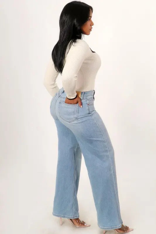 Close-up of asymmetrical waistband detail on high rise wide leg denim jeans