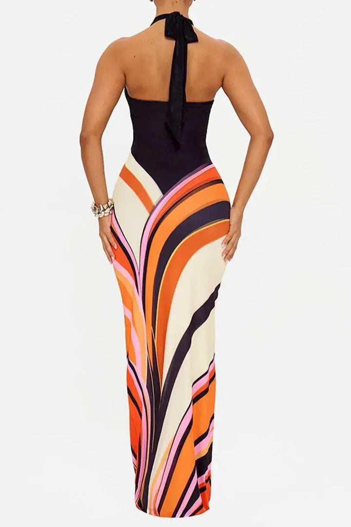 Back view of multi-color swirl halter maxi dress showing open tie-back halter neckline and swirl print maxi skirt 