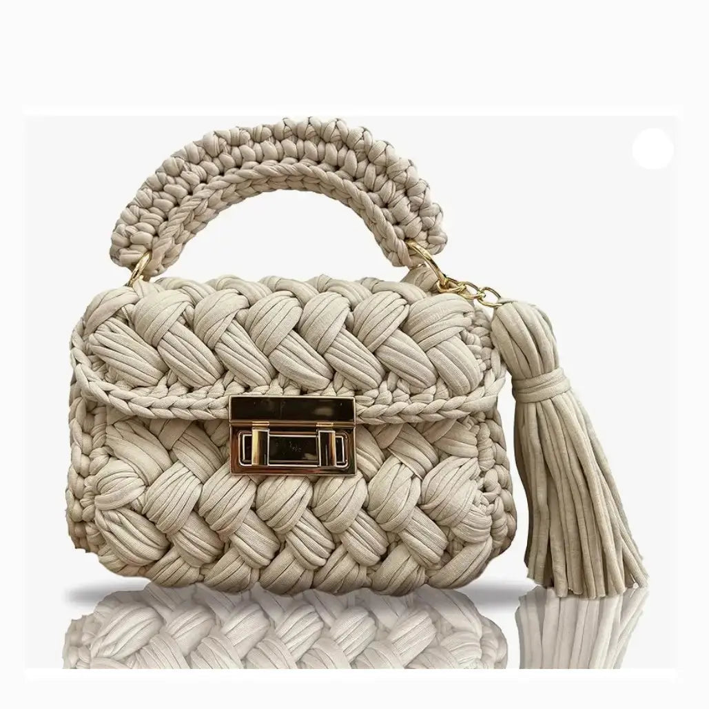 FASON DE VIV beige handmade crochet clutch bag with gold twist-lock closure and tassel detail