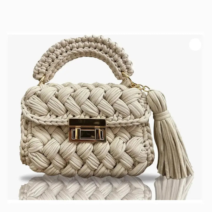 FASON DE VIV beige handmade crochet clutch bag with gold twist-lock closure and tassel detail