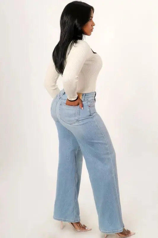 Close-up of asymmetrical waistband detail on high rise wide leg denim jeans