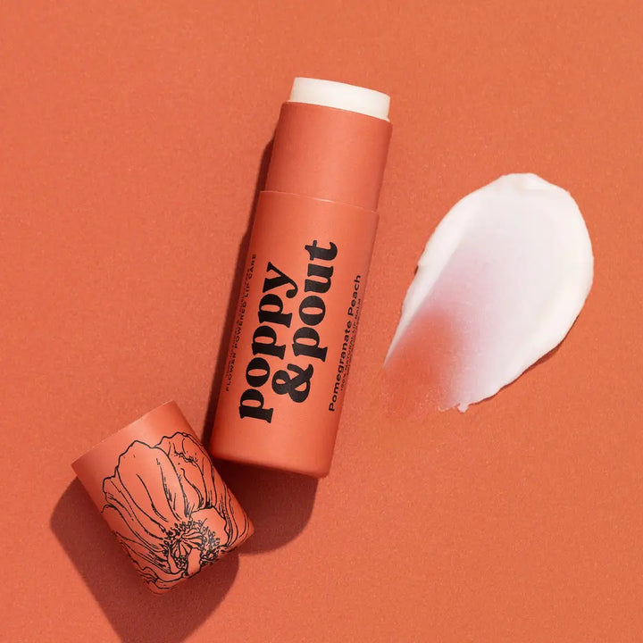 FASON DE VIV – Poppy &amp; Pout Pomegranate Peach Lip Balm tube open with product texture swatch on terracotta background