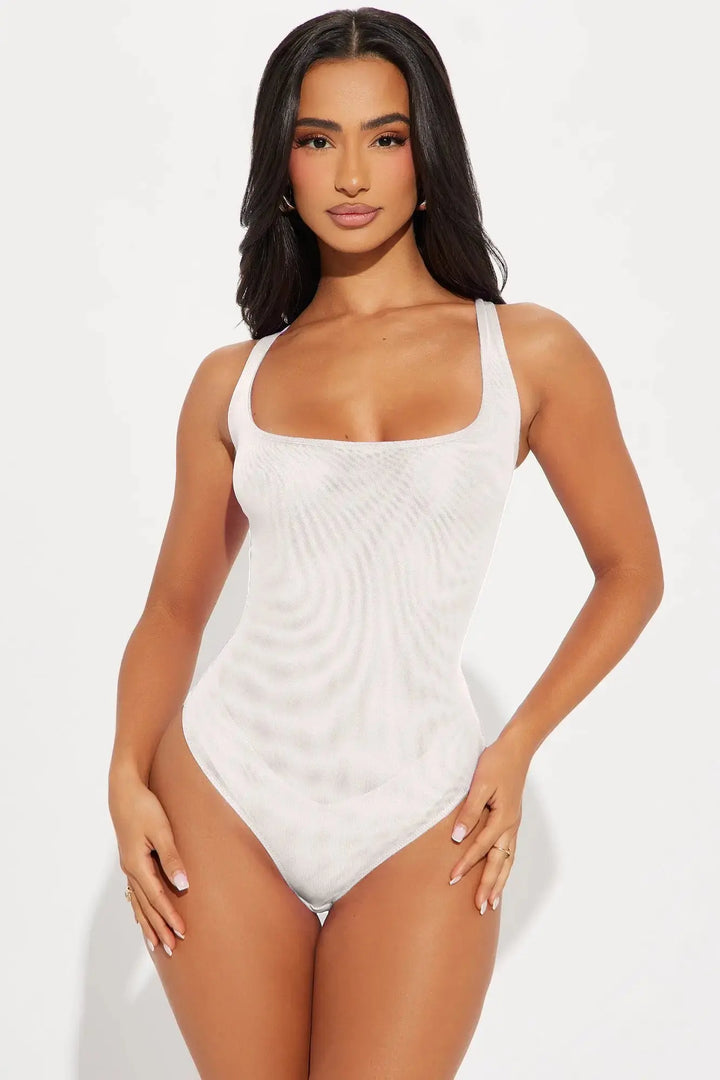 Front view of white mesh bodysuit with square neckline and thick straps on model on white background