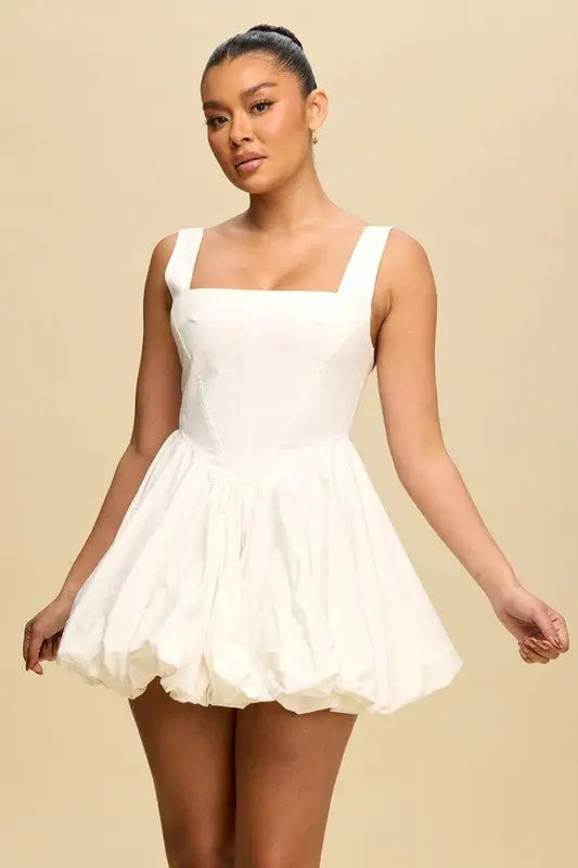 Woman wearing white cotton puff bubble hem mini dress with square neckline front view
